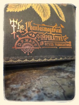 a close up faded image of the book featuring the title "The Phantasmagorical Imperative and Other Fabrications" in a sunburnt metallic orange